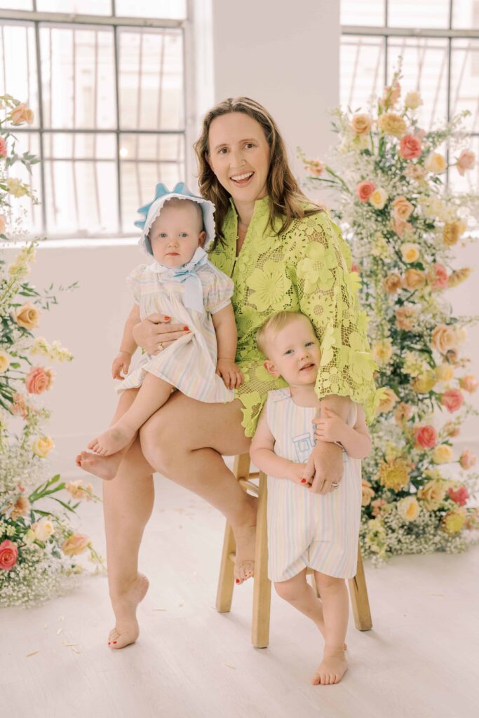 portrait of mom with her children in front of flowers